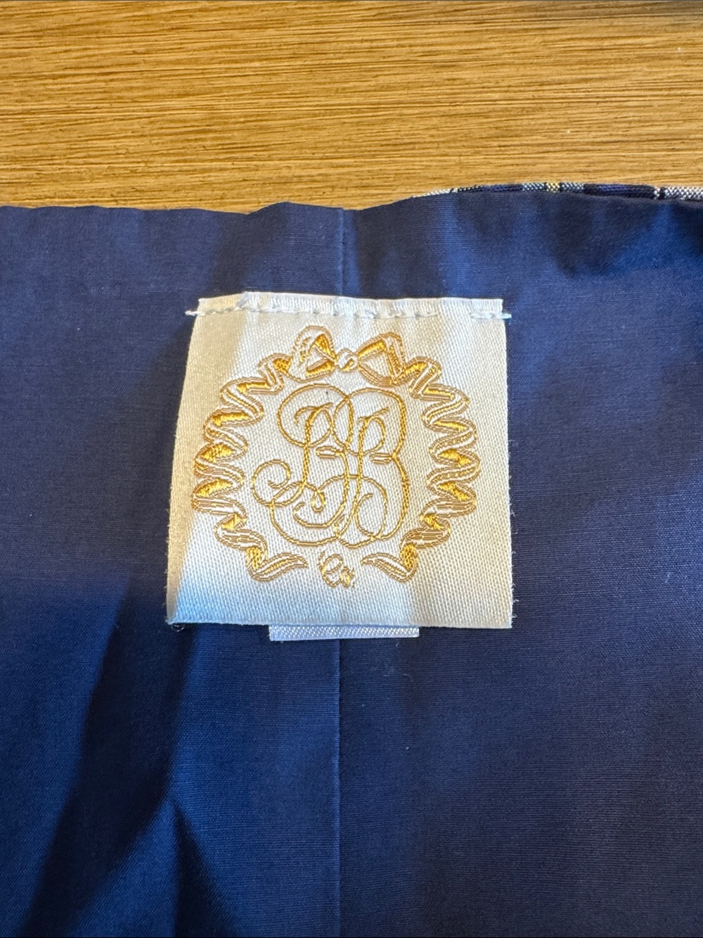 The Beaufort Bonnet Company Navy Baby Garment with Cream & Gold Tag